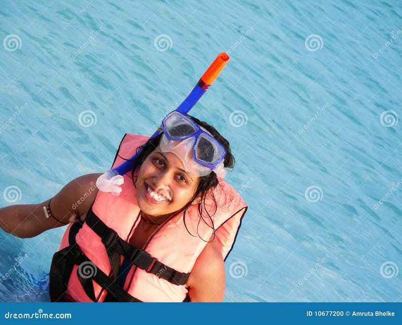 Crete: Snorkeling Boat Trip with Lunch and Transfer - Saint George Bay: sunbathing with a rocky, scenic backdrop
